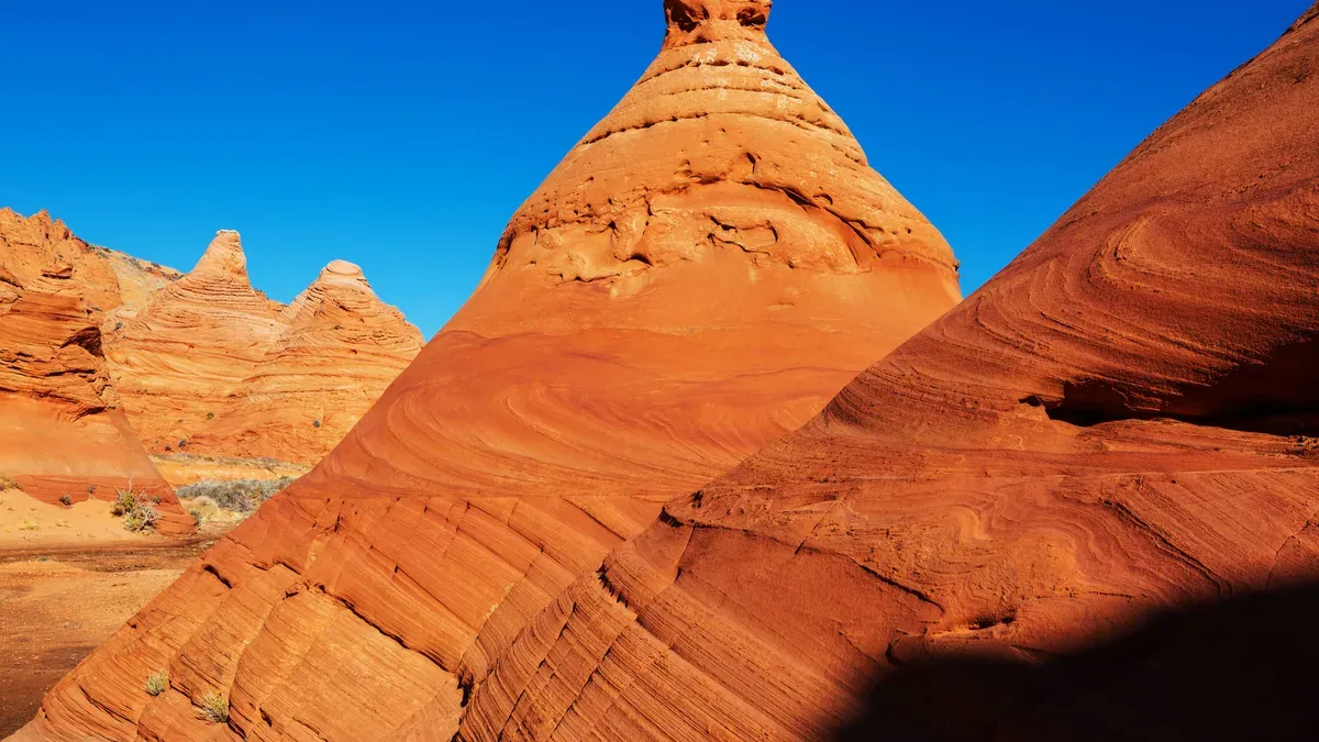 Sandstone teepee formations at South Coyote Buttes under blue sky
